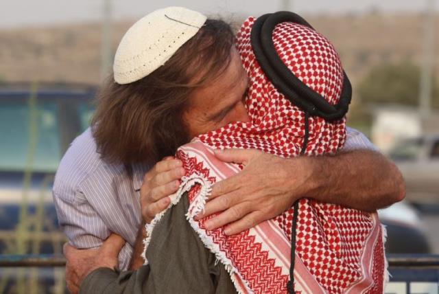 A rabbi and a sheikh embrace at a co-existence meeting (photo credit: MARC ISRAEL SELLEM)