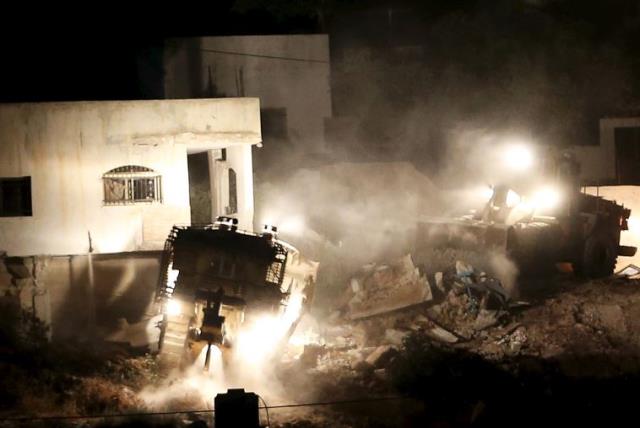 Israeli army machines demolish a Palestinian house during an Israeli raid in the West Bank city of Jenin (photo credit: REUTERS)
