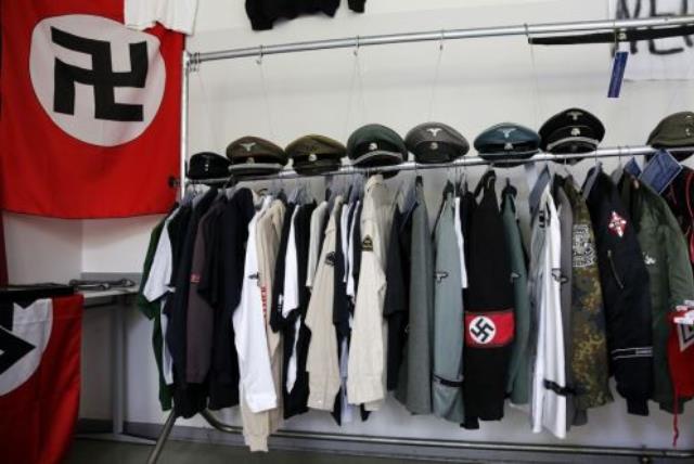Nazi uniforms and a Swastika flag that were confiscated by the Berlin police during raids against German neo-Nazis (photo credit: REUTERS)
