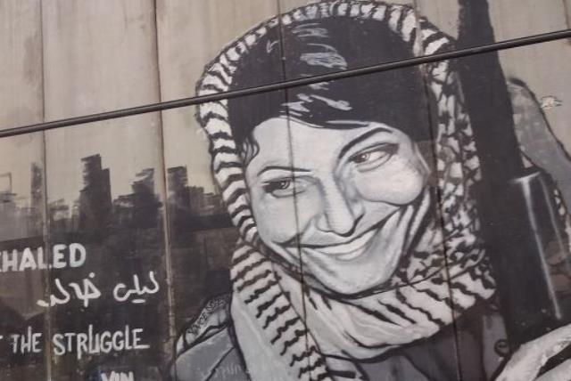 Graffiti depicting the PFPL plane hijacker Leila Khaled on the security barrier near Bethlehem (photo credit: Wikimedia Commons)