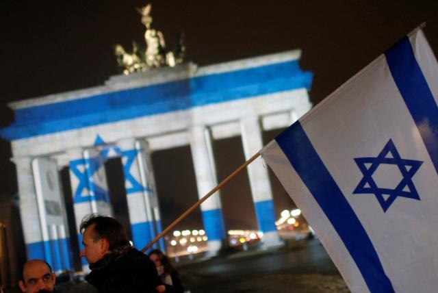 The Brandenburg Gate in Berlin, Germany, is illuminated with the colours of the Israeli flag to show solidarity with Israel (photo credit: REUTERS)