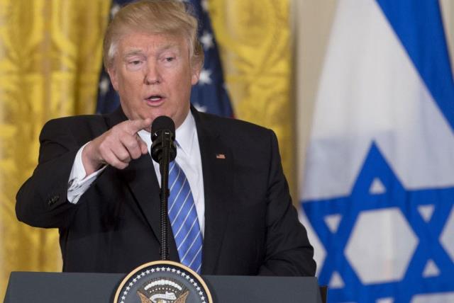Donald Trump speaks during a joint press conference with Minister Benjamin Netanyahu in the East Room of the White House in Washington , DC on Feb. 15, 2017 with an Israeli flag in the background (photo credit: SAUL LOEB / AFP)