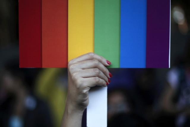A rainbow coloured placard in the colors of the LGBT flag [Illustrative] (photo credit: REUTERS)